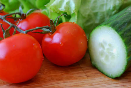 Tomatoes, cucumber and saladの写真素材