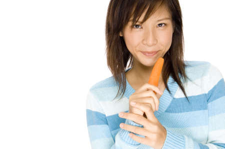 A girl holding a carrotの写真素材