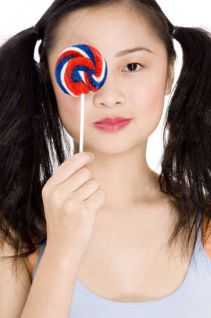 A sweet teenager holding a candy lollipopの写真素材