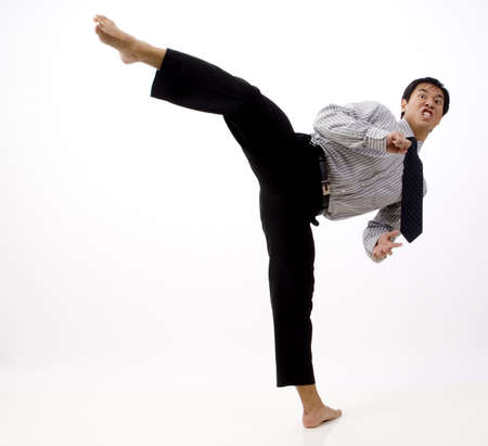 A businessman demonstrates a roundhouse kickの写真素材