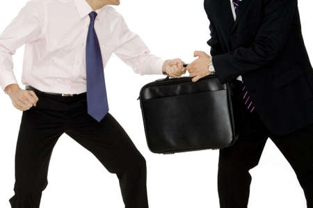 A businessman in pink passes a case to a man in a suit on white backgroundの写真素材