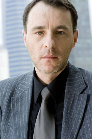 A businessman standing in front of city buildings (shallow depth of field used)
