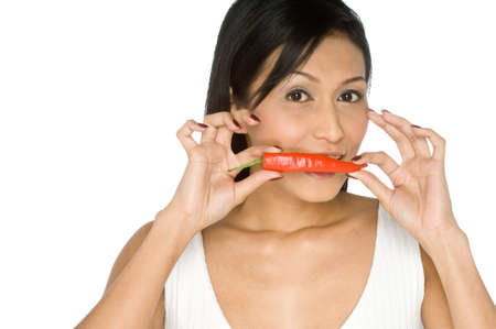 A young pretty Asian woman holding a red chilli pepperの写真素材