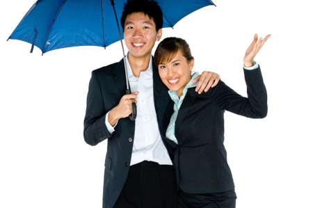 A young Asian couple in business attire with umbrella on white background