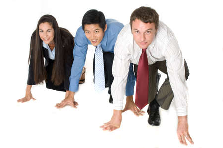 Three businessmen and woman crouched down ready to start a raceの写真素材