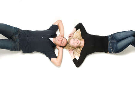 Young couple in love lying down togetherの写真素材