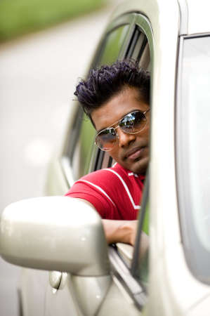 A cool young Asian man in carの写真素材