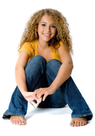 A happy teenage girl with curly hair on white backgroundの写真素材