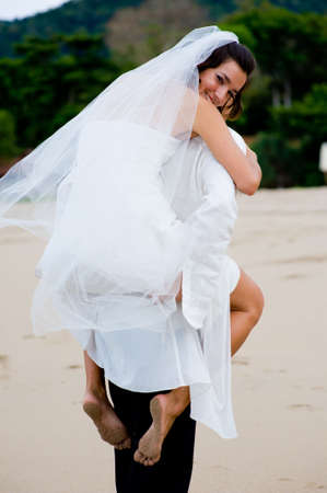 A young couple just married on a tropical beachの写真素材