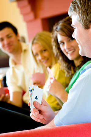 Four friends playing poker at home