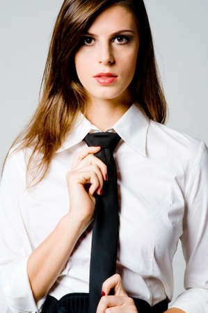 A sexy young businesswoman in blouse and tieの写真素材
