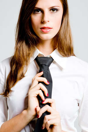 A young sexy businesswoman in blouse and tieの写真素材