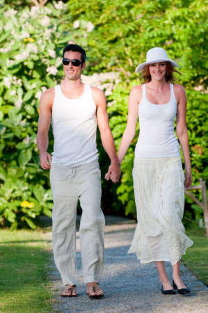 An attractive couple taking a walk through their resortの写真素材