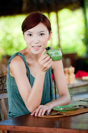 A beautiful woman with a cup of coffeeの写真素材