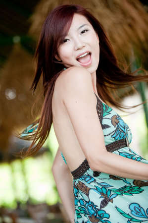 An attractive Chinese woman in a summer dressの写真素材