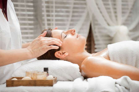 An attractive caucasian woman getting massaged in a spaの写真素材