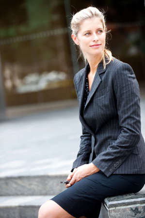 A young and attractive businesswoman sitting casuallyの写真素材