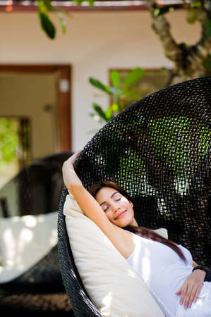 An attractive caucasian woman relaxing and lounging outdoorsの写真素材