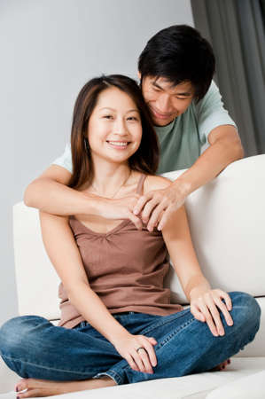 A good looking couple relaxing on their couch at homeの写真素材