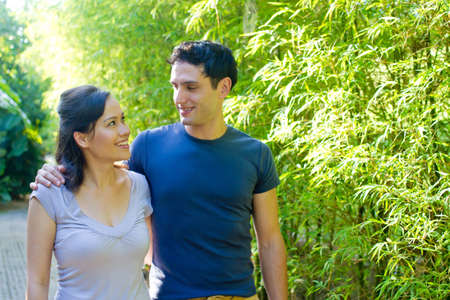 An attractive young couple relaxing outdoors together