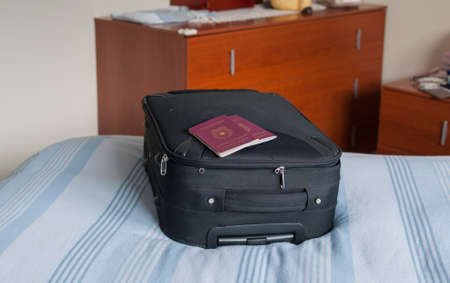 suitcase on the bed and passportsの写真素材