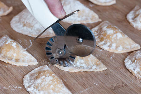 fresh homemade pasta cut with the pasta cutter wheelの写真素材