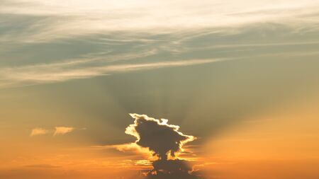The Sun go behind the unique cloud make a unique light at the evening timeの写真素材