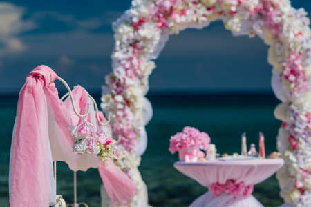 set of accessories for a wedding on the shores of the Caribbean Sea. Arch decorated with flowersの写真素材