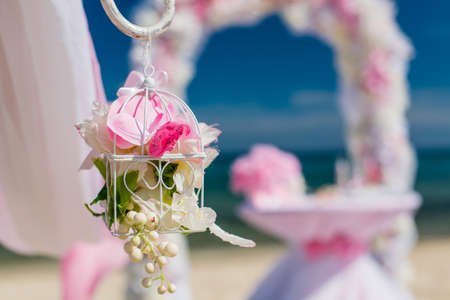 set of accessories for a wedding on the shores of the Caribbean Sea. Arch decorated with flowersの写真素材