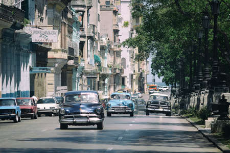HAVANA, CUBA - May 19, 2016: Hot summer sunny day in Cuba. Cars are riding on an empty street. View to the central district of Havana.のeditorial素材