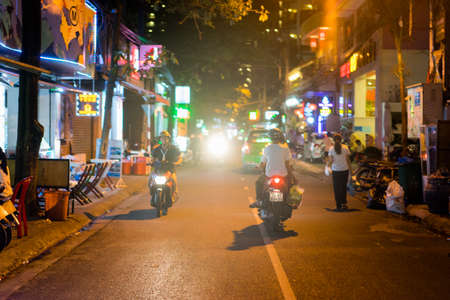 NHA TRANG, VIETNAM - JUNE 19, 2016: Nightlife of Vietnam. Motorcycles are riding on the empty lit street at night.のeditorial素材