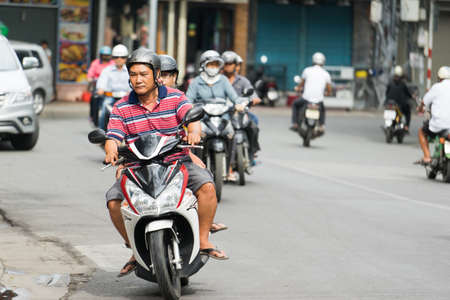 NHA TRANG, VIETNAM - JUNE 20, 2016: Road crowded with motorbikes and scooters drivers in the downtown of a city at daytimeのeditorial素材