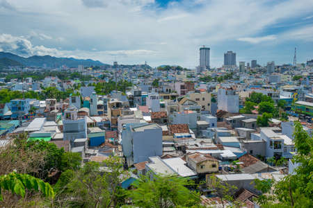 NHA TRANG, VIETNAM - JUNE 21, 2016: Bird's-eye view to houses and buildings of the city in Vietnam at hot sunny day with cloudy skyのeditorial素材