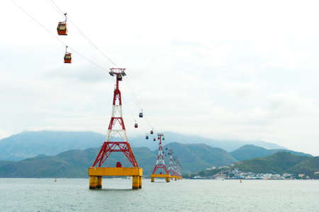 NHA TRANG, VIETNAM - JUNE 22, 2016: The funicular railway Vinpearl from one side of the river to another to mountains at sunny dayのeditorial素材