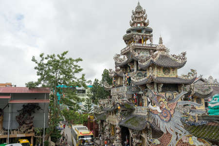 DA LAT, VIETNAM - JUNE 23, 2016: Multi-colored ornament of external design the Buddhist temple in Vietnam at cloudy dayのeditorial素材