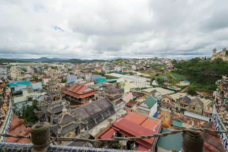 DA LAT, VIETNAM - JUNE 23, 2016: The top view on roofs of houses the city in Vietnam at cloudy day. Parks, forest and mountains are on the background.のeditorial素材