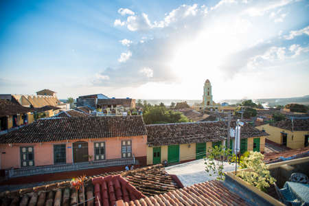 TRINIDAD, CUBA - FEBRUARY 25, 2014: Bird's-eye panoramic view around roofs of ancient houses, narrow streets, local buildings, central square and main yellow chapel in the city center at summer sunny morningのeditorial素材