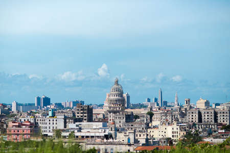 HAVANA, CUBA - AUGUST 31, 2014: View of the cityscape at summer sunny day. The reconstructed Capitol and architecture of old, ancient ragged houses and skyscrappers of Havana.のeditorial素材