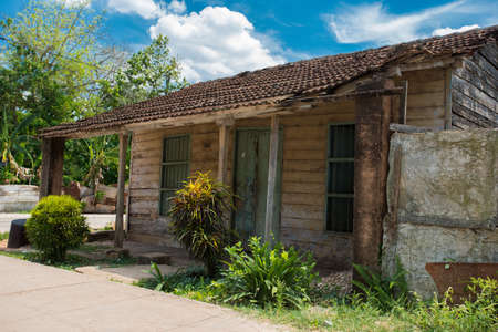 TRINIDAD, CUBA - APRIL 06, 2014: View to local street near the Caribbean Sea at summer sunny day. Small wooden shabby house is located at poor downtownのeditorial素材
