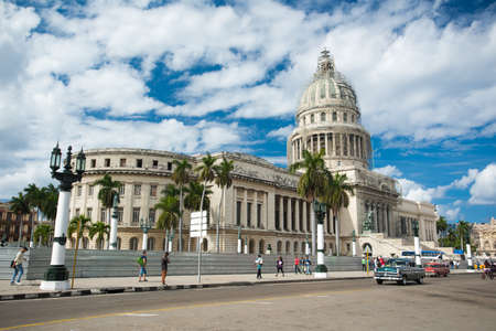 HAVANA, CUBA - JANUARY 25, 2015: Panoramic view to the cityscape of central street of Havana at summer sunny day. Tourists are walking around the Capitol and cars are riding on the main road.のeditorial素材