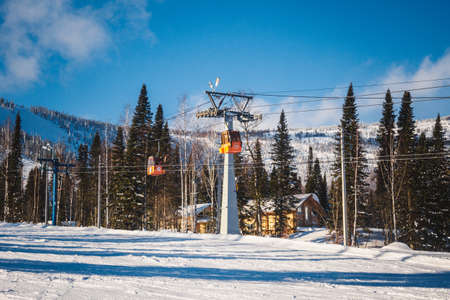 SHEREGESH, RUSSIA - DECEMBER 07, 2016: Winter landscape with rope tow to the top of the mountain. Panoramic view to ski resort with snow-covered hills on a background at sunny coldly dayのeditorial素材