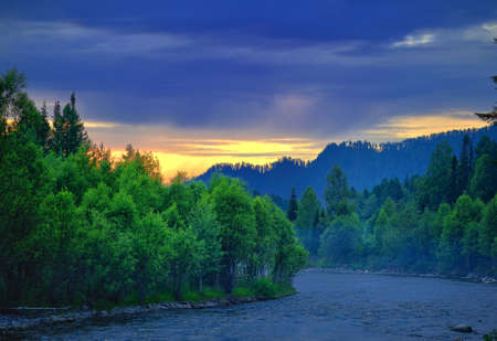 Mountain's river with clear blue water which flows through the forestの写真素材
