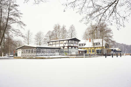 WUSTERHAUSEN, GERMANY - December 11, 2015: View from the frozen river Dosse to the houses on the shore of Wusterhausen on a winter dayのeditorial素材