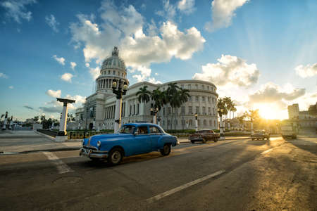 HAVANA, CUBA - NOVEMBER 05, 2016: Blue retro car and local autos are riding near the ancient colonial Capitol building in a central empty crossroad of Havana city at evening sunset timeのeditorial素材