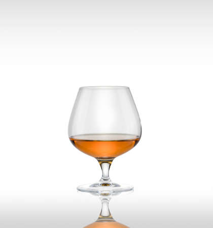 Cognac glass with brandy on a white background.の写真素材