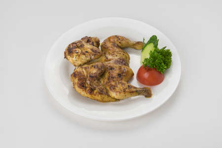 Grilled fried roast Chicken Tabaka on white plate.