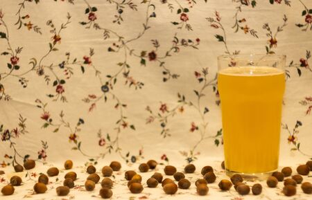 Nuts and white Beer on flowers backgroundの写真素材