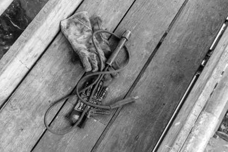 GULF OF THAILAND,OCTOBER 25,2017: Original Kong Glove and Norx Anti Hot Glove and  Lenco Electrode Holder lay down together on scaffold plank wood.のeditorial素材