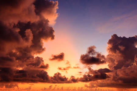 Red sky with sun red light reflexted in the warm cloud color background.
