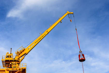 GULF OF THAILAND,SEPTEMBER 30,2017: Offshore oil and gas worker using personal basket for transfer by using crane for lift the passenger between supply boat and platformのeditorial素材